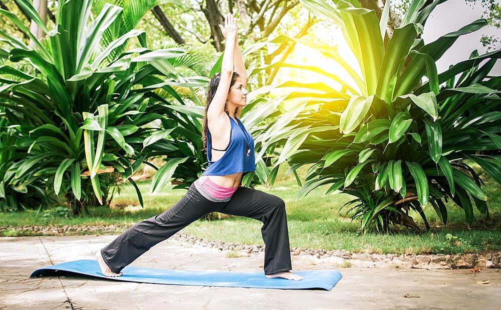 Woman doing yoga outdoors, A girl performing flexibility yoga, young girl showing yoga styles outdoors, yoga and fitness concept