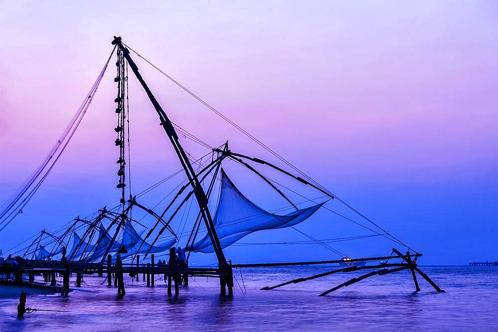 Kochi chinese fishnets on sunset in Fort Kochin, Kochi, Kerala, India, Asia