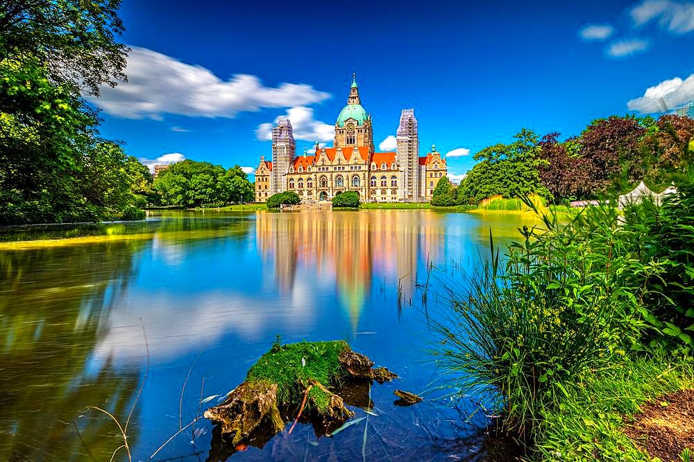 The new city hall of Hannover with the Maschpark and the Maschteich in the foreground with reflection in the water, in sunshine, blue sky and scattered clouds, Hannover, Lower Saxony, Germany, Europe