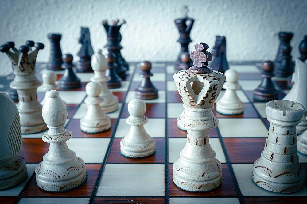 Chess with white wooden king in foreground in running game, Hanover, Lower Saxony, Germany, Europe