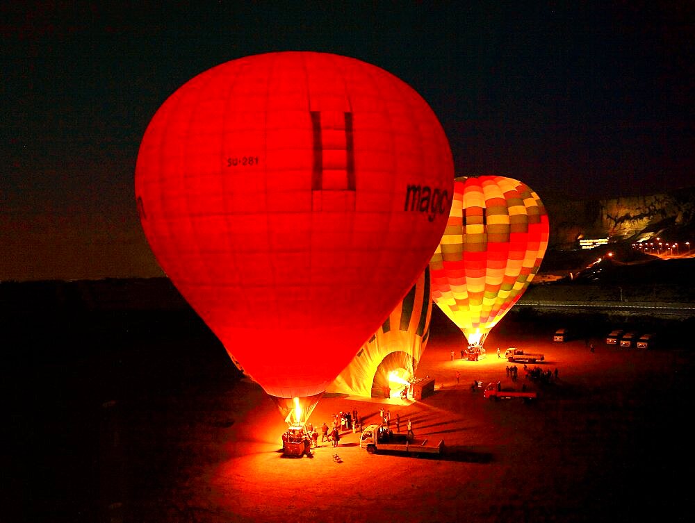 Hot air balloon, balloon glow in the early morning hours near Luxor, Egypt, Africa