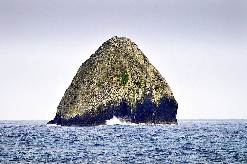 Lonely rock with surf at Cocos Island, UNESCO World Heritage Site, Costa Rica, Central America