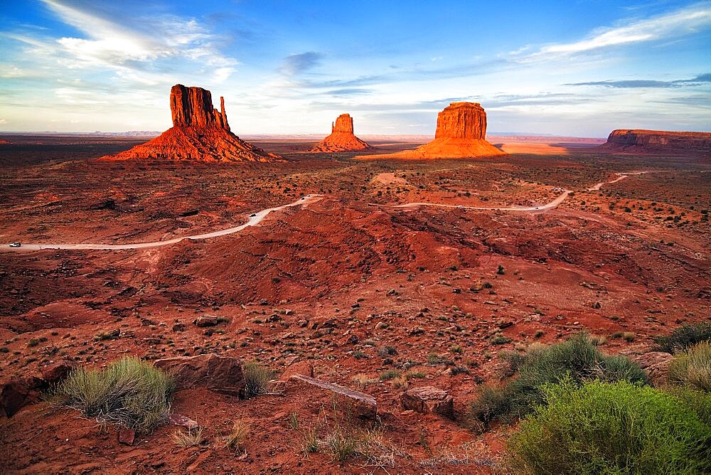 Panoramic road, gravel road in Monument Valley, prominent rocks, West Mitten Butte, East Mitten Butte, Merrick Butte on the horizon, dusk, film set, Arizona, USA, North America