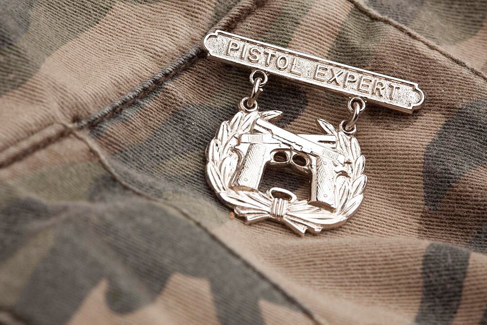 Pistol expert war medal on a camouflage background