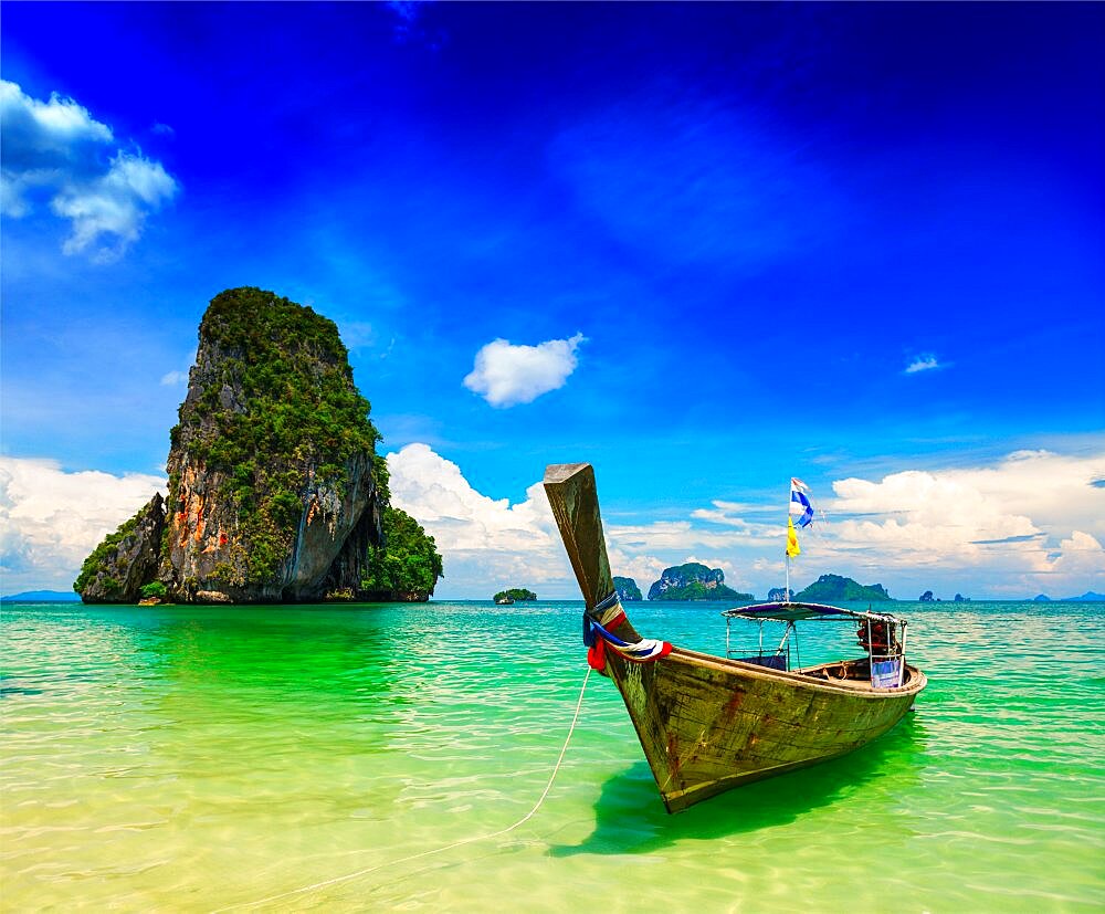 Long tail boat on tropical beach (Pranang beach) and rock, Krabi, Thailand, Asia