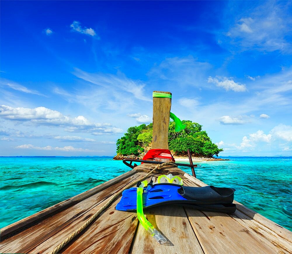 Vacation holidays adventure concept background, tropical island and long-tail boat with snorkeling set. Thailand