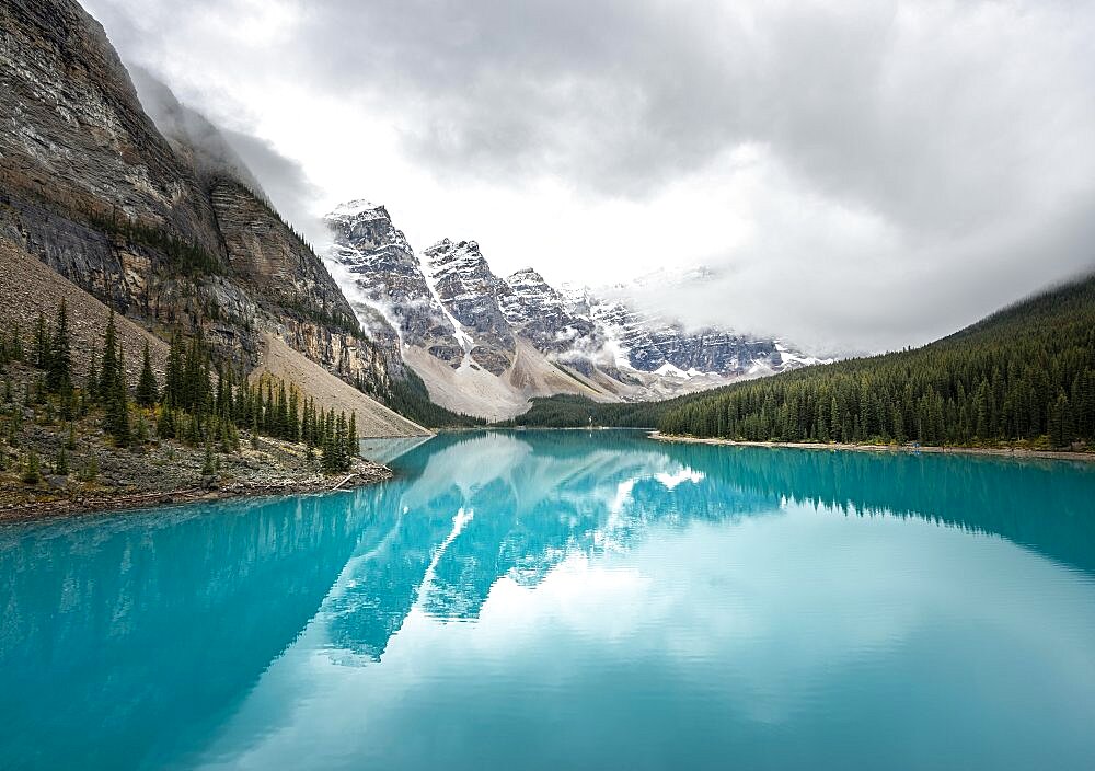 Cloudy mountain peaks, reflection in turquoise glacial lake, Moraine Lake, Valley of the Ten Peaks, Rocky Mountains, Banff National Park, Alberta Province, Canada, North America