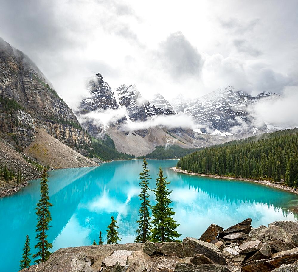 Cloudy mountain peaks, reflection in turquoise glacial lake, Moraine Lake, Valley of the Ten Peaks, Rocky Mountains, Banff National Park, Alberta Province, Canada, North America