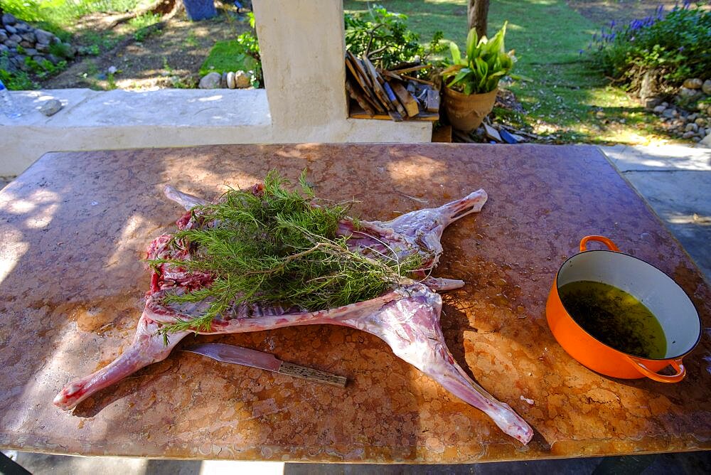 Whole lamb marinating in oil rub and rosemary for asado, in Altea La Vella, Alicante, Spain, Europe