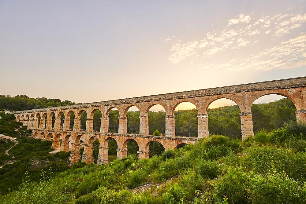 Old roman aqueduct at sunrise, Aqueeducte de les Ferreres, Devil's Bridge, Pont del Diable, Catalonia, Spain, Europe