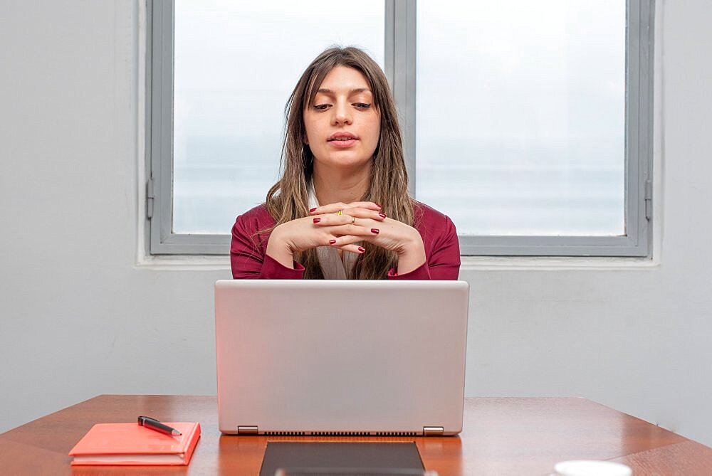 Woman concentrated on her work while she is looking at her laptop