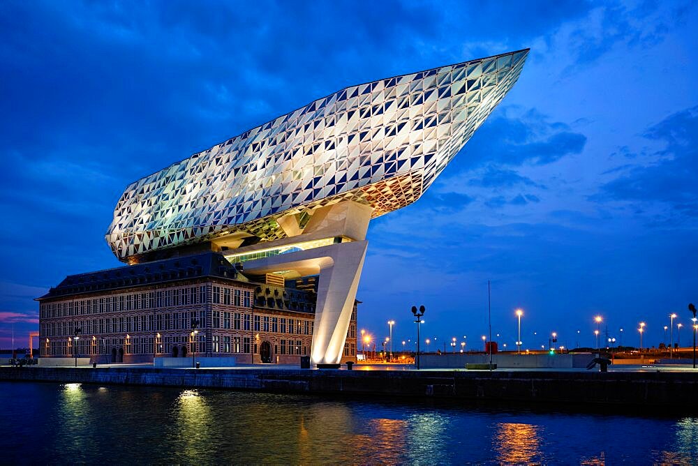 ANTWERP, BELGIUM, MAY 27, 2018: Antwerp port administration headquarters, designed by famous iranian architect Zaha Hadid, Antwerpen, Belgium illuminated at night