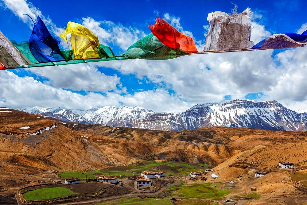 Buddhist prayer flags lungta with Om mani padme hum. . mantra written on them in sky over Comic Village. Spiti Valley, Himachal Pradesh, India, Asia