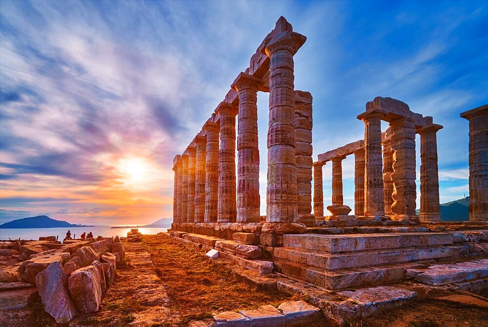 Greece Cape Sounio. Ruins of an ancient temple of Poseidon, Greek god of the sea, on sunset. Shot of temple ruins on sunset. Tourist landmark of Attica, Sounion, Greece, Europe