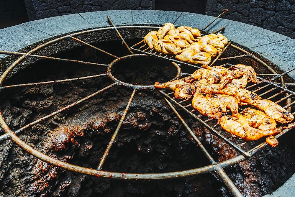 Tasty meat barbecued on volcanic heat, Timanfaya National Park, Canary Islands, Spain, Europe