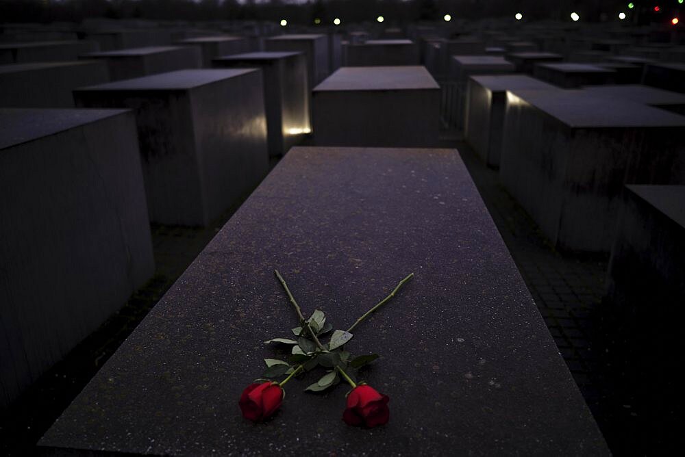 Germany, Berlin, 27. 01. 20222, Holocaust Memorial, on the 76th anniversary of the liberation of the Auschwitz-Birkenau extermination and concentration camp, red roses, stones, Europe