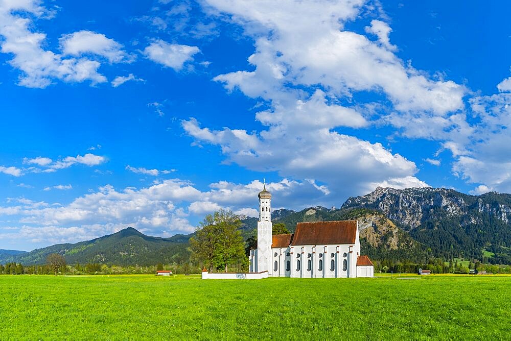 Baroque church of St. Coloman, behind it the Tegelberg mountain range, 1881m, Schwangau, Ostallgaeu, Allgaeu, Swabia, Bavaria, Germany, Europe