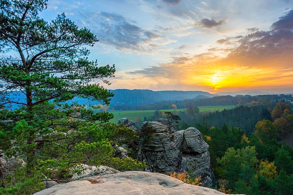 Sunrise in the mountains with a rocky peak in the foreground, Rathen, Saxon Switzerland, Saxony, Germany, Europe