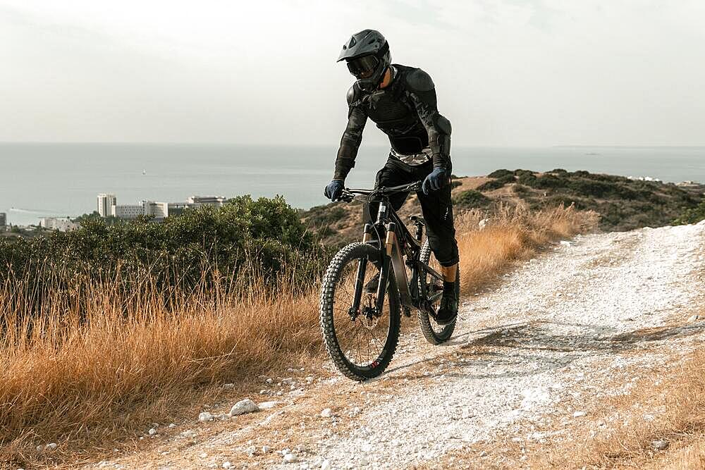 man mountain biking equipment riding his bike