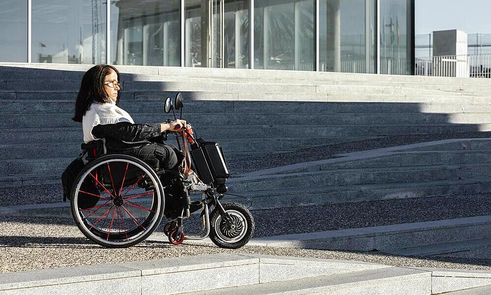 side view woman wheelchair street with copy space