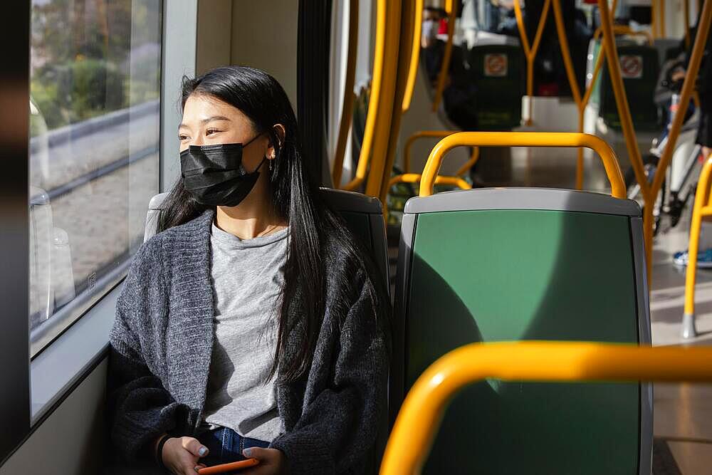 Young woman with mask bus