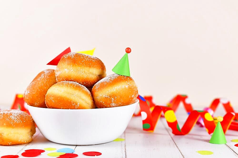 Bowl with German traditional 'Berliner Pfannkuchen', a donut without hole filled with jam. Traditional served during carnival