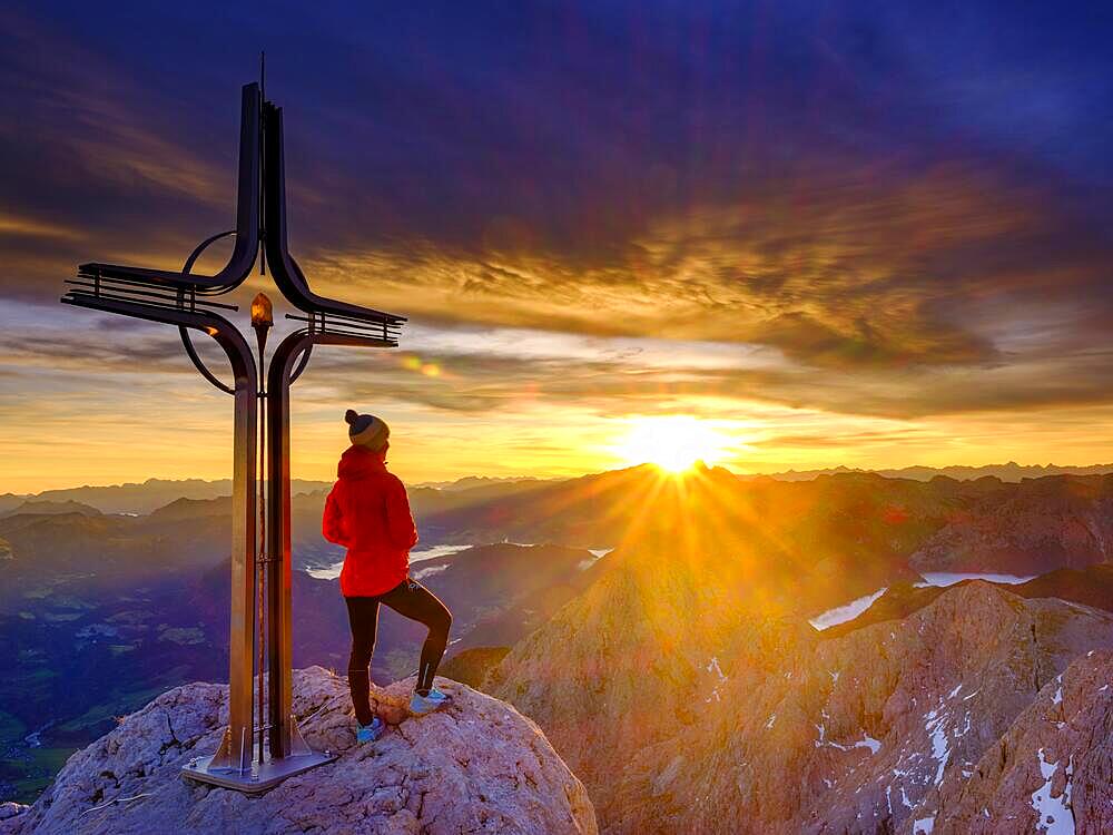 Mountaineer at the summit cross Hohe Goell at sunrise, Berchtesgaden Alps, Berchtesgaden National Park, Schoenau am Koenigssee, Berchtesgadener Land, Upper Bavaria, Bavaria, Germany, Europe