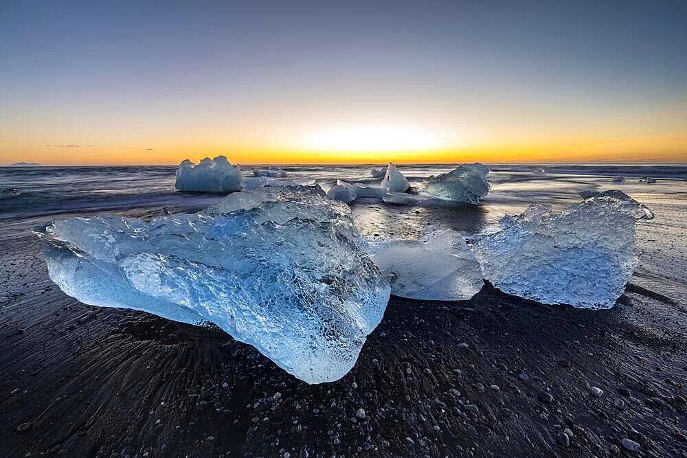 Diamond Beach, icebergs on black lava beach, at Joekulsarlon glacier lagoon, sunrise, Vatnajoekull National Park, Hornafjoerour, South Iceland, Iceland, Europe