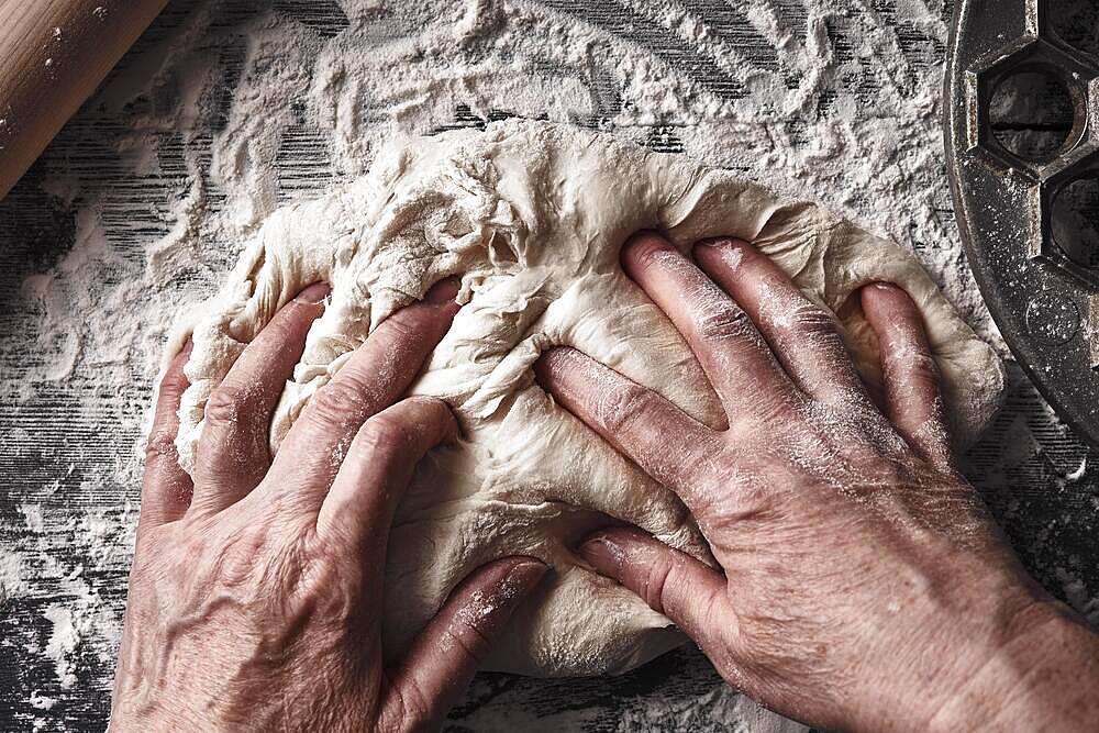 Cooking dough by elderly woman cook hands for homemade pastry bread, pizza, pasta recipe preparation on table background