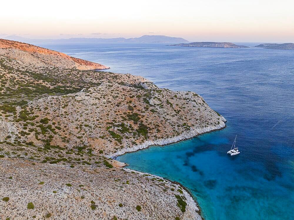 Sailing catamaran in a bay of Levitha Island, Greek Island, South Aegean Sea, Greece, Europe