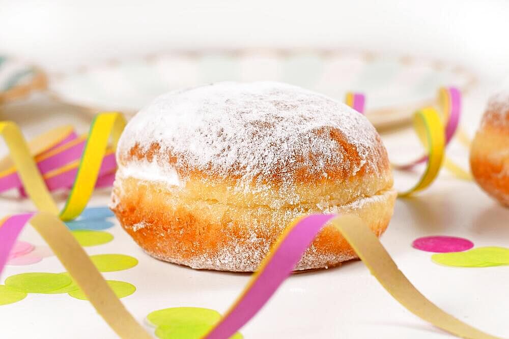 Single Berliner Pfannkuchen, a traditional German donut like dessert filled with jam made from sweet yeast dough fried in fat. Traditional served during carnival