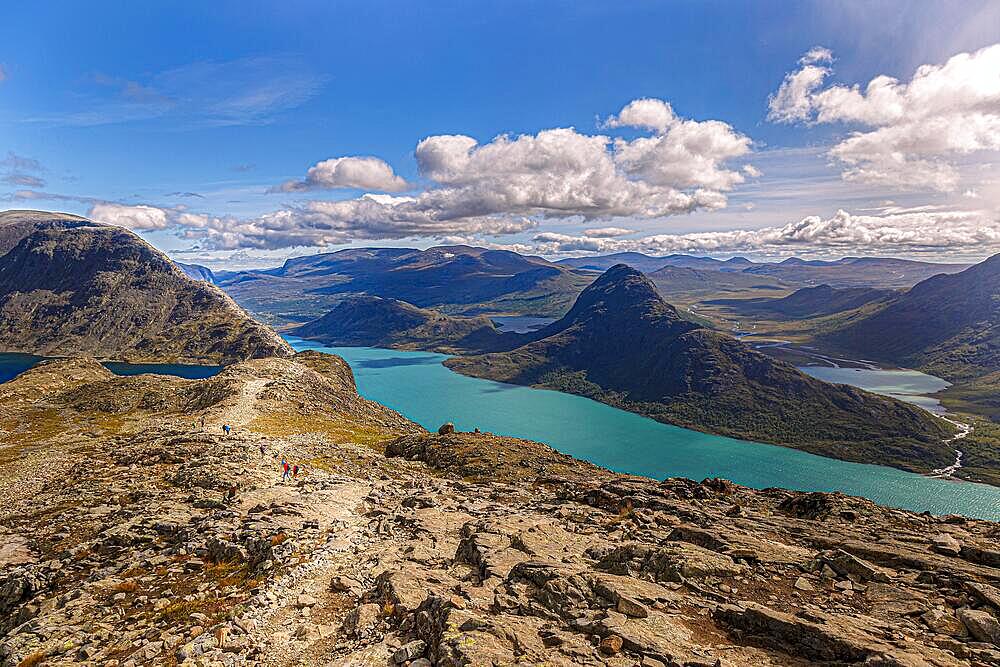 Hikers walking on the famous Besseggen ridge in the Jotunheimen mountains, Norway, Europe