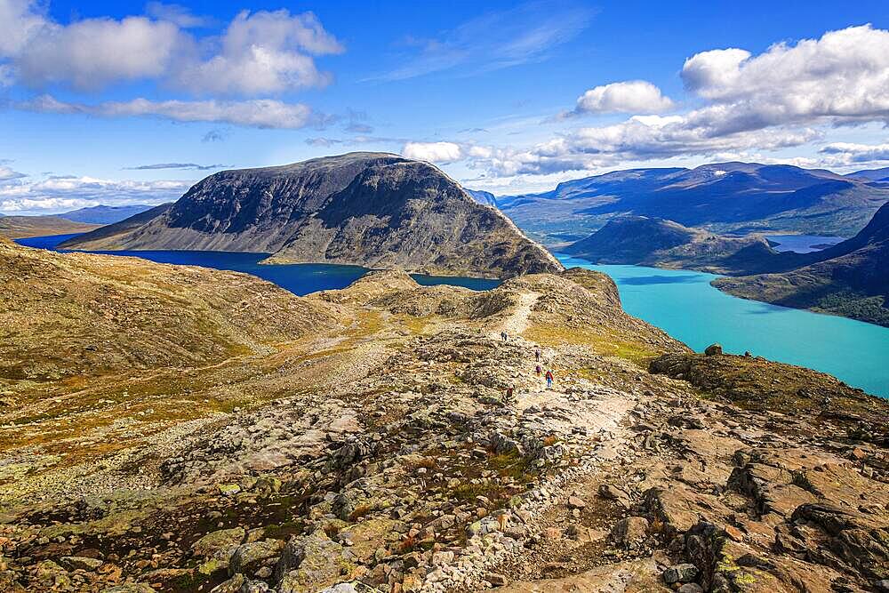 Hikers walking on the famous Besseggen ridge in the Jotunheimen mountains, Norway, Europe