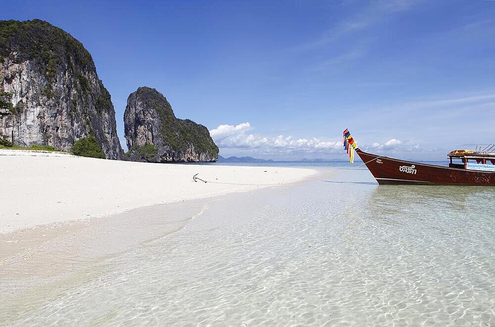 Karst rocks and white sandy beach, longtail boat in crystal clear sea, Koh Lao Liang, Andaman Sea, Southern Thailand, Thailand, Asia