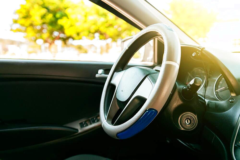 Close up of car steering wheel. Side view of a car steering wheel. A car wheel with copy space