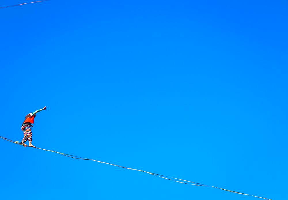 LANZO, ITALY - CIRCA OCTOBER 2020: Slackline athlete during his performance. Concentration, balance and adventure in this dynamic sport