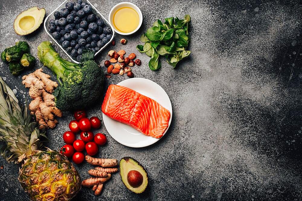 Anti inflammatory diet concept. Set of foods that help to reduce inflammation - plant based ingredients, fresh fruit, vegetables. Healthy diet products, top view, stone background copy space. Toned