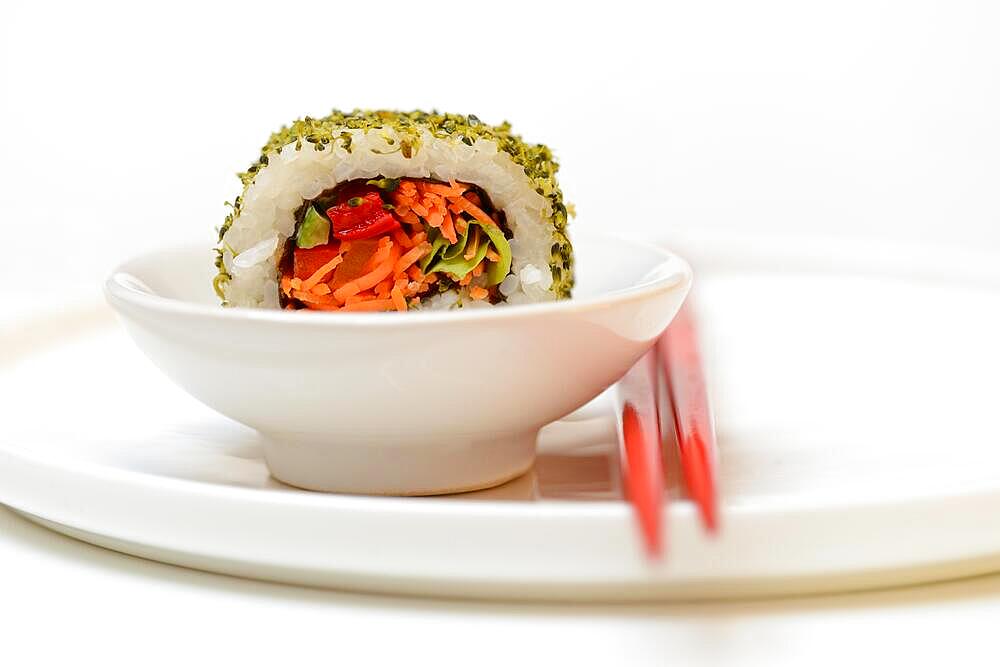 Vegetarian sushi in bowls and chopsticks