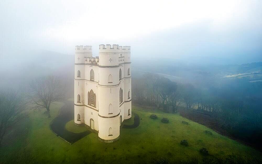 Misty morning over Haldon Belvedere from a drone, Lawrence Castle, Higher Ashton, Exeter, Devon, England, United Kingdom, Europe