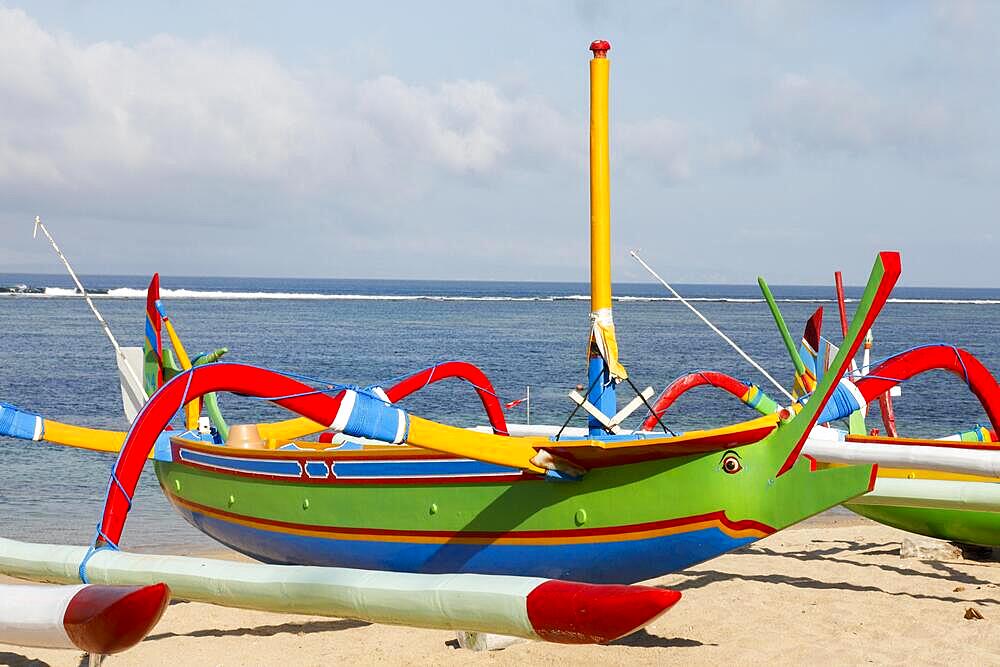 Brightly painted fishing outriggers on the beach at Sanur, Bali, Indonesia, Asia