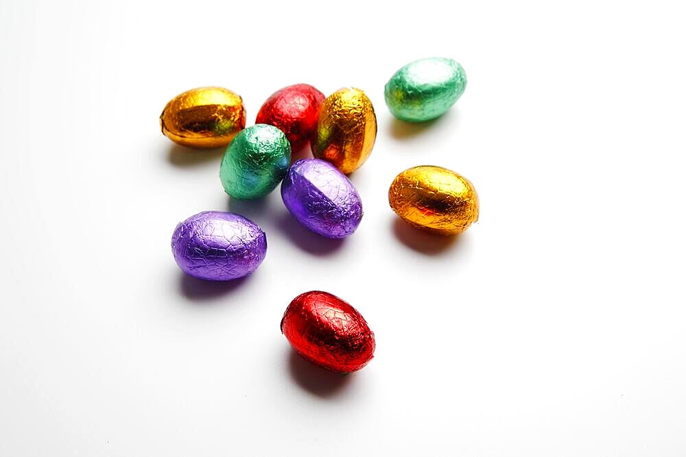 Small chocolate Easter eggs on a white background