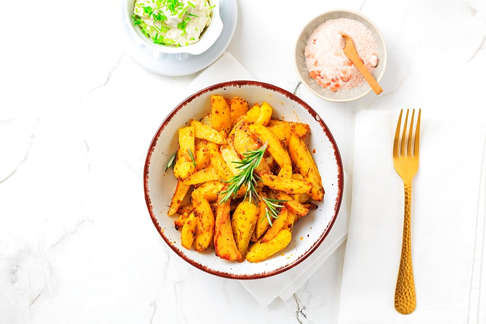 Homemade baked potato wedges with garlic dip