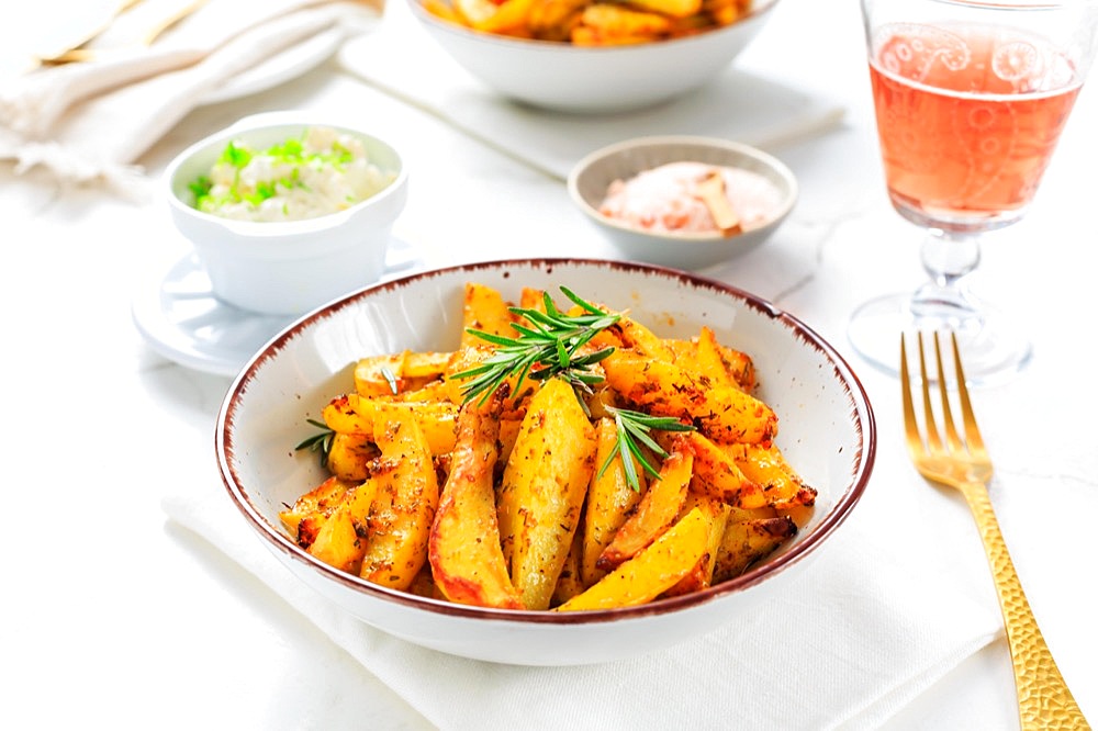 Homemade baked potato wedges with garlic dip