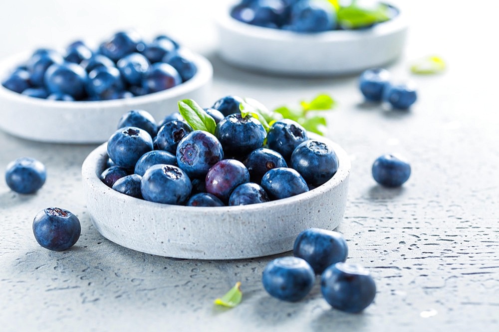 Fresh organic blueberries on stone background