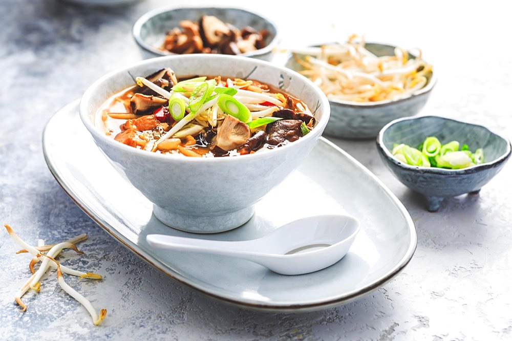 Asian soup with shiitake mushrooms, noodles, vegetables and bamboo sprouts