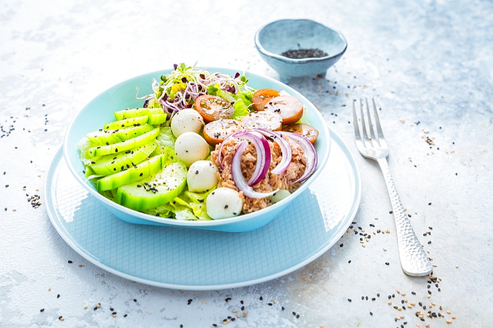 Fresh green mixed salad bowl with tuna, mozzarella and microgreens