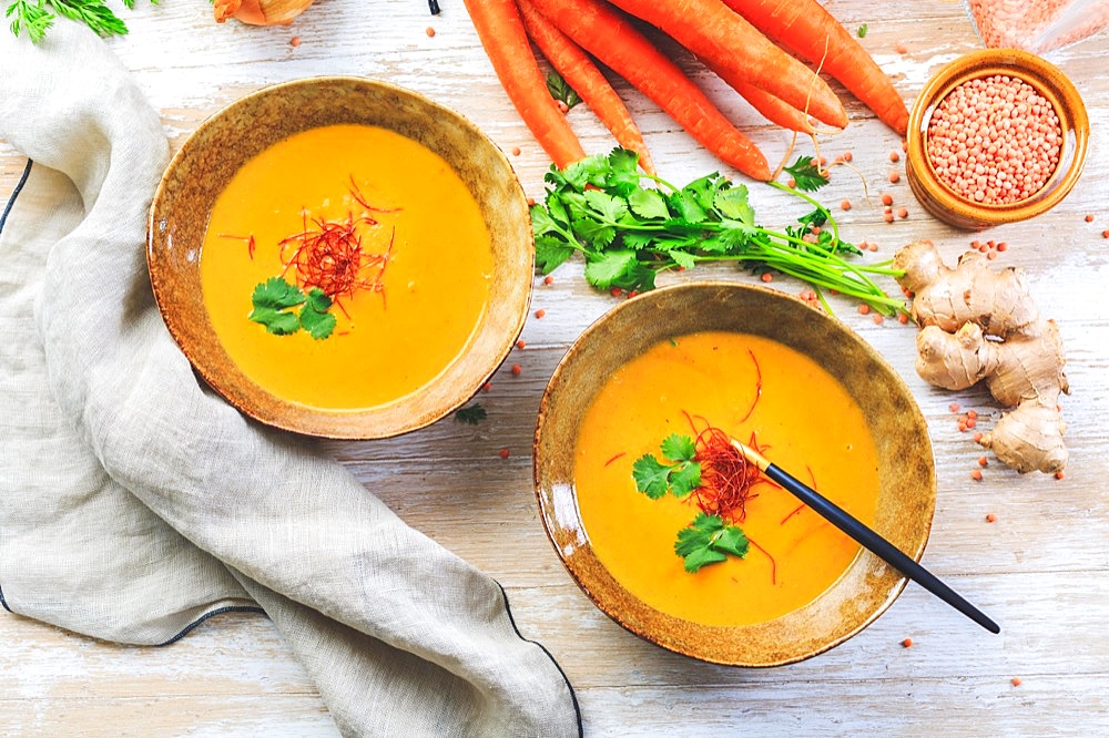 Homemade red lentil soup with carrots, ginger and coconut milk with ingredients