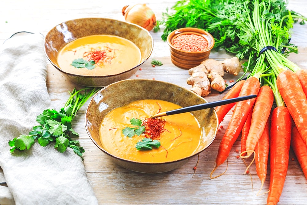 Homemade red lentil soup with carrots, ginger and coconut milk with ingredients