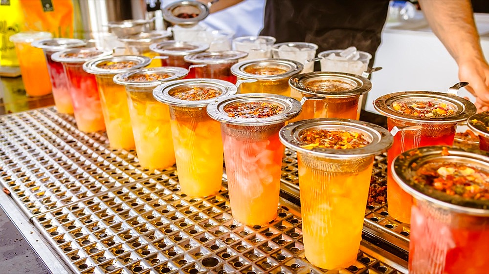 Preparing fresh brewed ice tea. Street food and refreshment