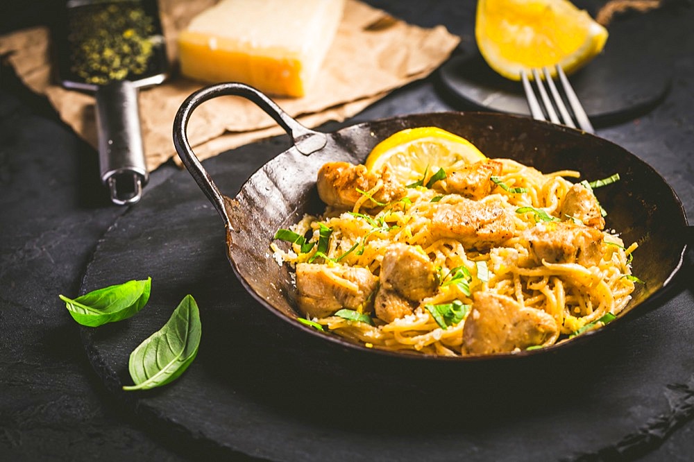 Lemon Chicken Pasta in cast iron pan with basil and Parmesan